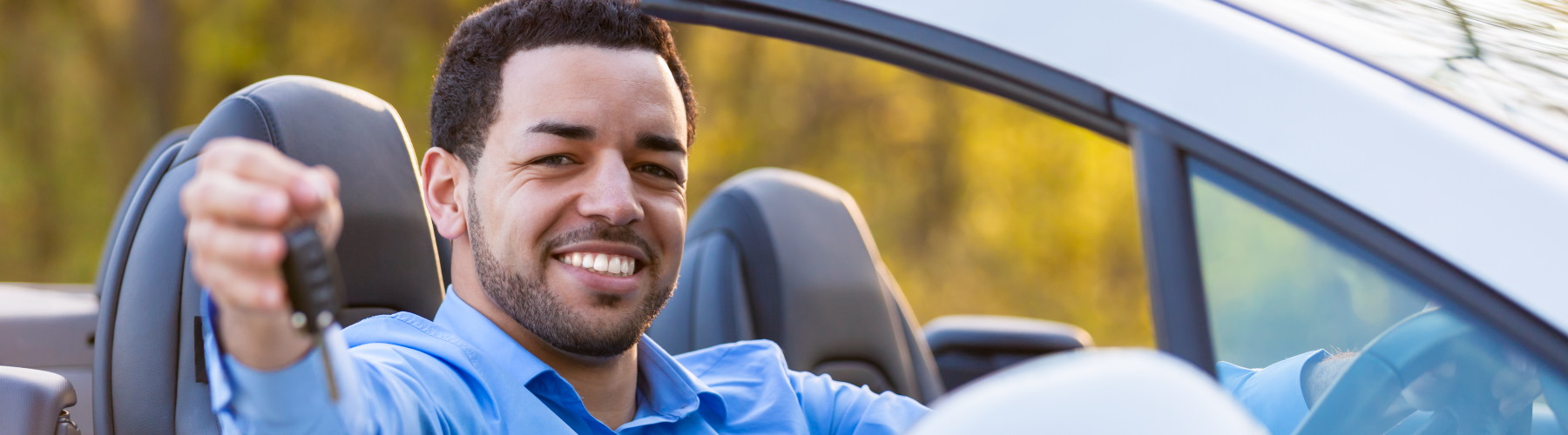 man sitting in drivers seat of a vehicle